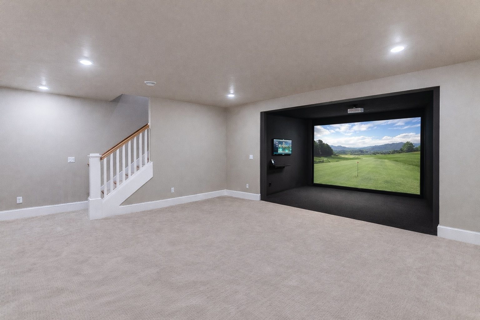 Basement golf simulator enclosure with impact screen and projector