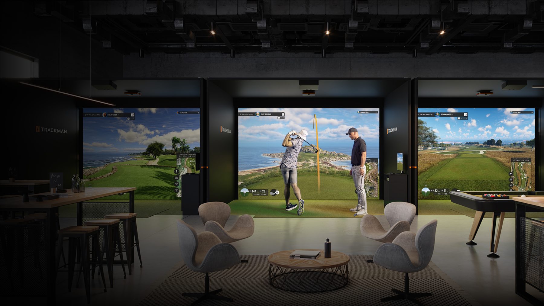 Golf simulator bays with comfortable lounge seating positioned behind the hitting area