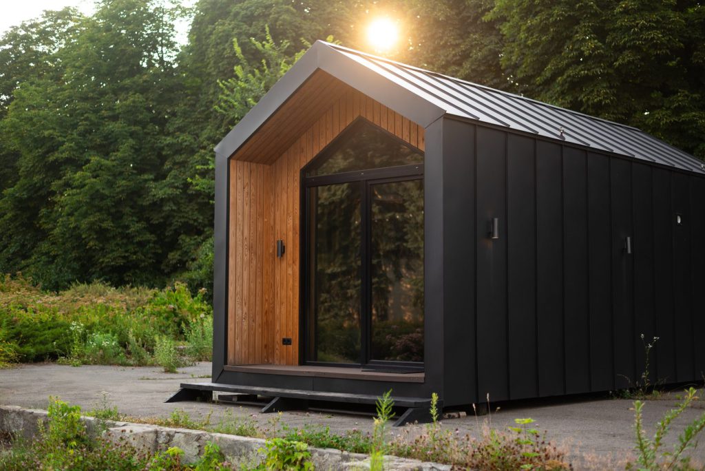 Modern black backyard golf simulator shed